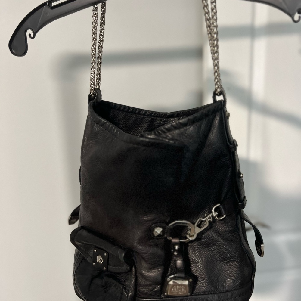Henry Bendel, black leather bag with purple lining and silver chain accent